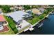 Aerial view of backyard featuring a screened pool, deck, and boat lift on a waterfront canal at 9810 Compass Point Way, Tampa, FL 33615