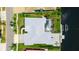 Aerial view showcasing the house with the screen enclosed pool, wooden deck, and boat lift on the canal at 9810 Compass Point Way, Tampa, FL 33615