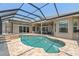 Backyard with a beautiful pool, spa, and covered patio at 9810 Compass Point Way, Tampa, FL 33615