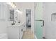 Modern bathroom featuring a double sink vanity, white marble shower, and contemporary fixtures with a glimpse of the bedroom at 9810 Compass Point Way, Tampa, FL 33615
