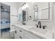 Modern bathroom featuring double sinks, marble countertop, and black fixtures, adjacent to a bedroom at 9810 Compass Point Way, Tampa, FL 33615