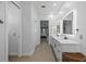 Bathroom with double sinks, modern fixtures, large well lit mirrors and access to the bedroom at 9810 Compass Point Way, Tampa, FL 33615