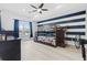 Spacious bedroom with a bunk bed, wood floors, blue curtains, and a ceiling fan at 9810 Compass Point Way, Tampa, FL 33615