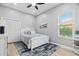 Cozy bedroom with blue accents, white furniture, and a ceiling fan at 9810 Compass Point Way, Tampa, FL 33615