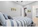 Bright bedroom with light gray walls and a blue and white striped comforter on the bed at 9810 Compass Point Way, Tampa, FL 33615