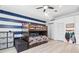 A bunkbed decorates this bedroom with light wood floors, recessed lighting, and striped blue accent wall at 9810 Compass Point Way, Tampa, FL 33615