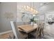 Dining room showcasing a light wood table, six chairs, modern lighting, and an open floor plan with access to outdoor space at 9810 Compass Point Way, Tampa, FL 33615