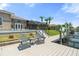 Waterfront dock with chairs, ideal for relaxing and enjoying the picturesque canal and beautiful Florida homes at 9810 Compass Point Way, Tampa, FL 33615