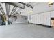 Spacious garage features epoxy floors, storage cabinets, and organized shelving for tools and equipment at 9810 Compass Point Way, Tampa, FL 33615