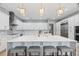 Bright kitchen boasts white cabinets, marble countertops, brass hardware, and a large island with seating at 9810 Compass Point Way, Tampa, FL 33615