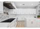 Bright kitchen boasts white cabinets, marble countertops, stainless steel appliances, and modern backsplash at 9810 Compass Point Way, Tampa, FL 33615