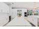 Bright kitchen boasts white cabinets, marble countertops, stainless steel appliances, with an island snack bar at 9810 Compass Point Way, Tampa, FL 33615