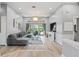 Bright living room with a high ceiling, large windows, modern decor, and a gray sectional sofa at 9810 Compass Point Way, Tampa, FL 33615