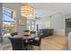 Eat-in kitchen offers a modern light fixture, dinette table, and plenty of natural light at 9810 Compass Point Way, Tampa, FL 33615