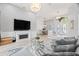 An open concept living room with modern decor, fireplace, a clear view into a dining area, and a staircase at 9810 Compass Point Way, Tampa, FL 33615