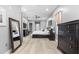 Spacious main bedroom featuring light wood floors, fan, dresser, and a large mirror at 9810 Compass Point Way, Tampa, FL 33615