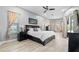 Light-filled main bedroom with wood-look floors, neutral walls, and a large bed at 9810 Compass Point Way, Tampa, FL 33615