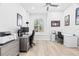 Bright home office with two desks, ample natural light, and wood-look floors at 9810 Compass Point Way, Tampa, FL 33615