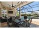 Relaxing covered patio with outdoor seating, television, ceiling fans and view of the pool at 9810 Compass Point Way, Tampa, FL 33615