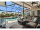 Beautiful outdoor patio with wicker seating, ceiling fans, and a view of the pool and spa at 9810 Compass Point Way, Tampa, FL 33615