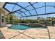 Enclosed pool area with a spa and view of a canal at 9810 Compass Point Way, Tampa, FL 33615