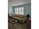 Cozy living room featuring large window with shutters and comfortable seating area at 6339 Delaware Ave, New Port Richey, FL 34653