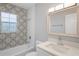 Bathroom with shower/tub, decorative tile, modern vanity, and natural light at 1000 Magnolia Dr, Clearwater, FL 33756