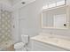 Bathroom featuring decorative tile in the shower, a modern vanity, and ample lighting at 1000 Magnolia Dr, Clearwater, FL 33756