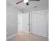 Bedroom featuring wood floors, closet with sliding doors, and neutral colored walls at 1000 Magnolia Dr, Clearwater, FL 33756