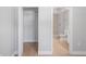 Bedroom featuring wood floors, closet, and bathroom with a walk-in shower at 1000 Magnolia Dr, Clearwater, FL 33756
