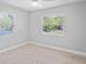 Bedroom featuring wood floors, natural light, and neutral colored walls at 1000 Magnolia Dr, Clearwater, FL 33756