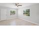 Light-filled bedroom featuring a ceiling fan, neutral walls, and light hardwood floors at 1000 Magnolia Dr, Clearwater, FL 33756