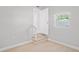 Bright entryway with hardwood floors, natural light, and staircase leading to the upper level at 1000 Magnolia Dr, Clearwater, FL 33756