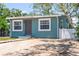 Home featuring a well-maintained lawn, new driveway, and inviting curb appeal at 1000 Magnolia Dr, Clearwater, FL 33756