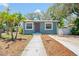 Charming home featuring a well-maintained lawn, a quaint walkway, and inviting curb appeal at 1000 Magnolia Dr, Clearwater, FL 33756
