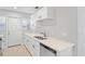 Modern kitchen featuring stainless steel appliances, white cabinets, stone countertops, and new sink at 1000 Magnolia Dr, Clearwater, FL 33756
