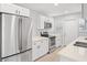Modern kitchen featuring stainless steel appliances, white cabinets, and stone countertops at 1000 Magnolia Dr, Clearwater, FL 33756