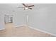 Spacious living room featuring neutral walls, light hardwood floors, and a ceiling fan at 1000 Magnolia Dr, Clearwater, FL 33756