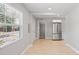 Open living room featuring a stainless refrigerator, light hardwood floors, and neutral walls at 1000 Magnolia Dr, Clearwater, FL 33756