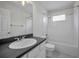Bathroom with dark granite countertop, white cabinets, and a shower/tub combo at 10344 Tecoma Dr, Trinity, FL 34655