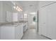 Bathroom with double sinks and a view into the bedroom at 10344 Tecoma Dr, Trinity, FL 34655