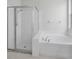 Bathroom featuring a separate glass shower and bathtub at 10344 Tecoma Dr, Trinity, FL 34655