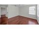 Bright, empty bedroom features hardwood floors and a large window at 10344 Tecoma Dr, Trinity, FL 34655