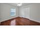 Bedroom with hardwood floor, ceiling fan, and window at 10344 Tecoma Dr, Trinity, FL 34655