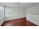 Upstairs bonus room with hardwood floors, ceiling fan and natural light at 10344 Tecoma Dr, Trinity, FL 34655