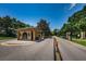 Elegant gated community entrance with well-maintained landscaping and a secure entry point at 10344 Tecoma Dr, Trinity, FL 34655