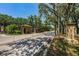 Gated entrance with palm trees to a secure residential community, lush trees and landscaping at 10344 Tecoma Dr, Trinity, FL 34655