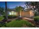 Charming single-Gathering home features a well-manicured lawn and front garden under a lovely colorful sky at 10344 Tecoma Dr, Trinity, FL 34655
