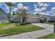Charming single-Gathering home features a well-manicured lawn and a two-car garage on a bright sunny day at 10344 Tecoma Dr, Trinity, FL 34655