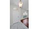 Bright foyer features tile flooring, half-moon window over door, and hanging light fixture at 10344 Tecoma Dr, Trinity, FL 34655